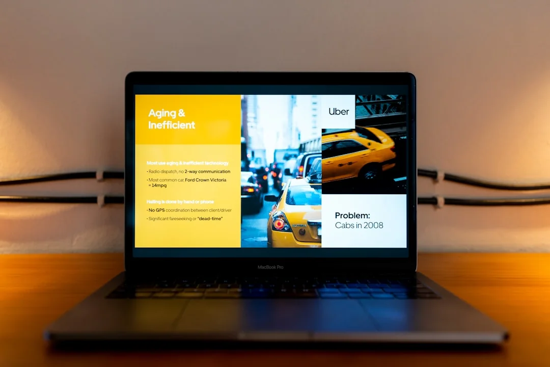 A laptop on a bed showing web design software, creating a cozy workspace.